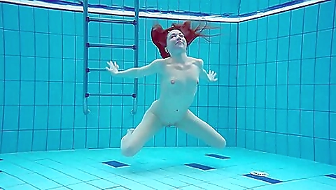 Sexy milf looks under the water and shows off her body