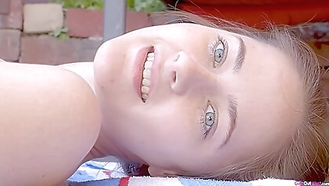 A sexy brunette naked in sun letting her sun-beautified body show