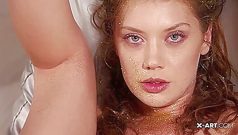 Sexy brunette milf in pure gold is playing with her own dildo