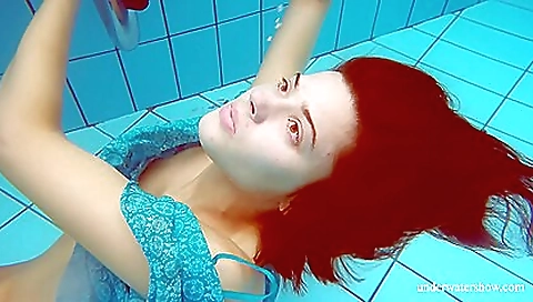 Red-haired redhead has a hairy pussy under the water