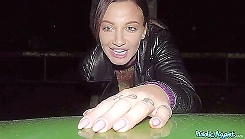 Tattooed woman in stockings walking down the street