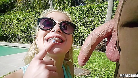 Blonde babe in a braceface looks beautiful in a sexy outfit