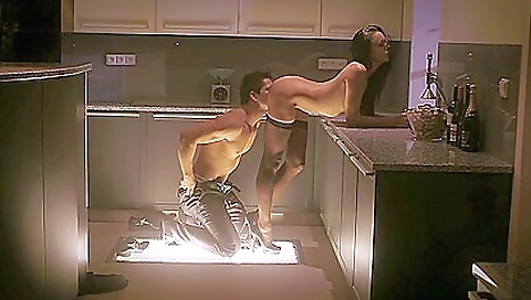 Hot brunette girl is on top of a sofa and wearing stockings